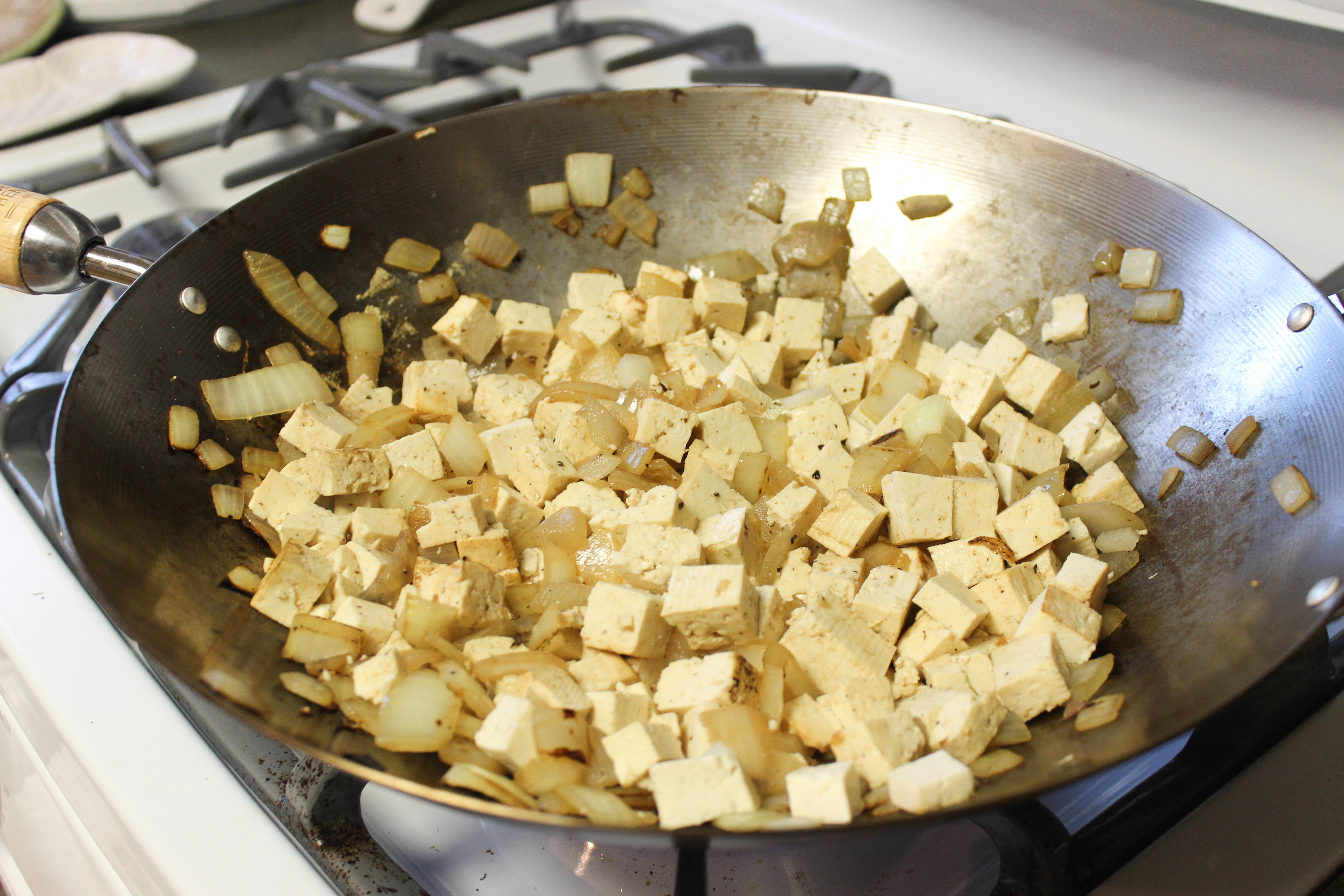 I used a wok because A. it's the largest pan I own, and B. I'm a sloppy cook and it keeps me from flipping the tofu all over the stove top while doin' the choppy choppy on that stuff.