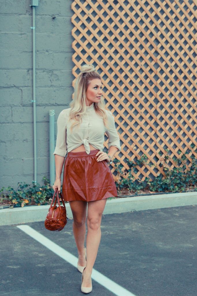 A deep red leather skater skirt paired with a victorian style button up blouse.
