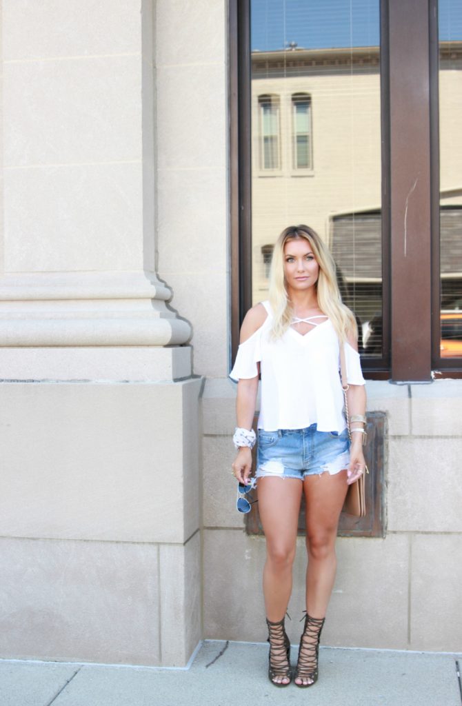 Ripped jean shorts with lace up booties.
